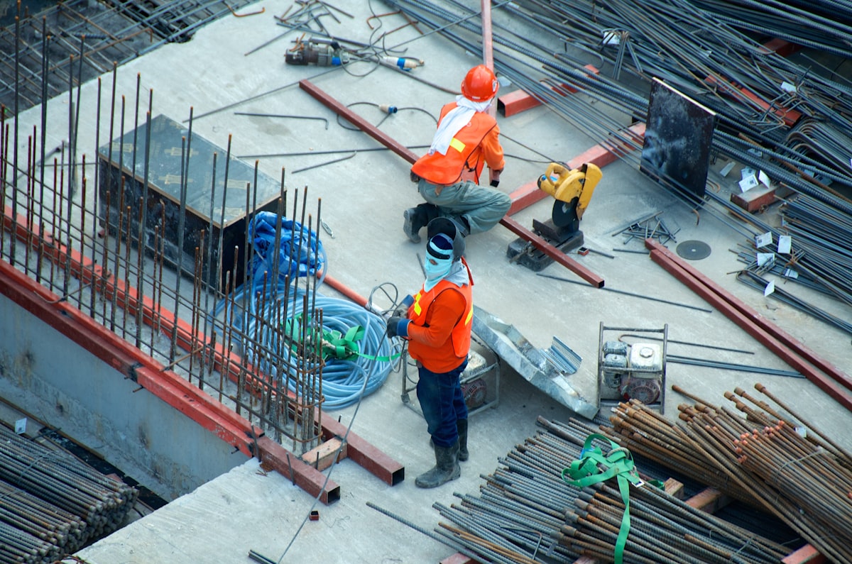 Professional roofers in safety gear carrying out roof repairs on the Central Coast