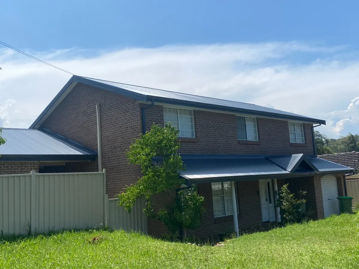 Completed metal roof on a two-storey brick home, Central Coast