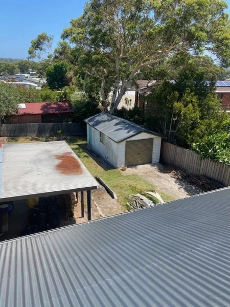 Completed metal roof above a Central Coast backyard