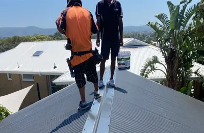 Our crew coating a metal roof — Central Coast